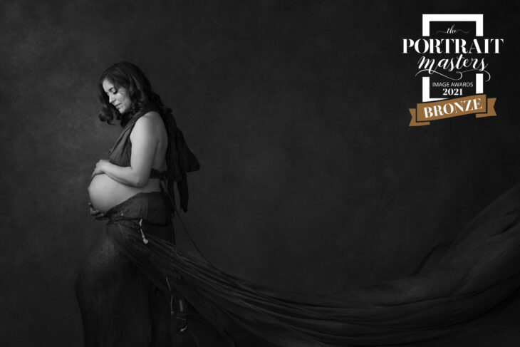 award winning maternity portrait of a woman in a parachute dress in black and white